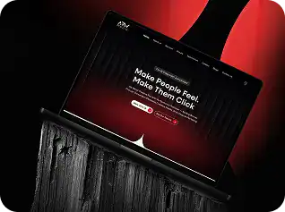 Modern website homepage on a laptop with a red and black theme.