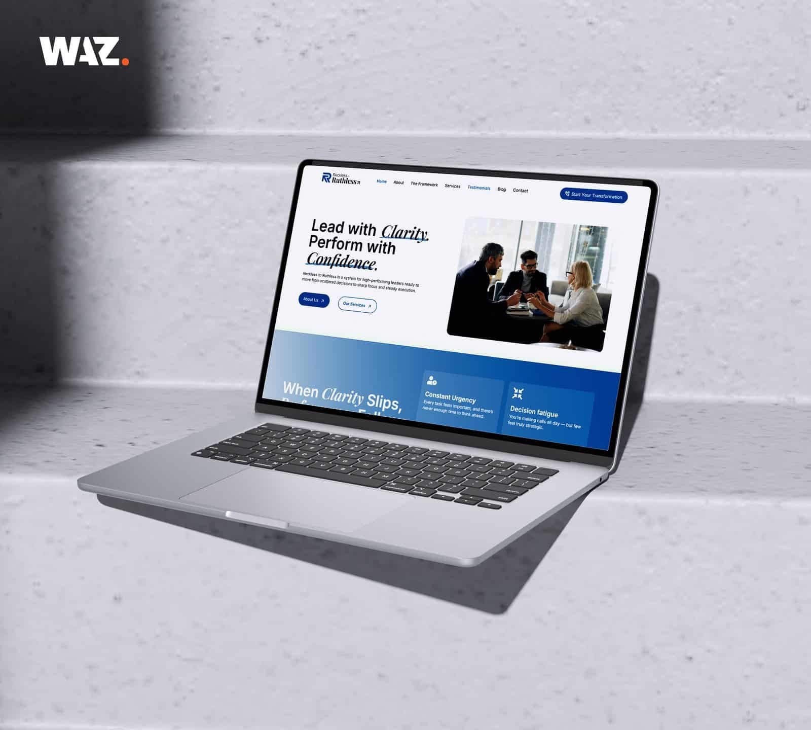 Laptop showing a business website on a white textured surface.